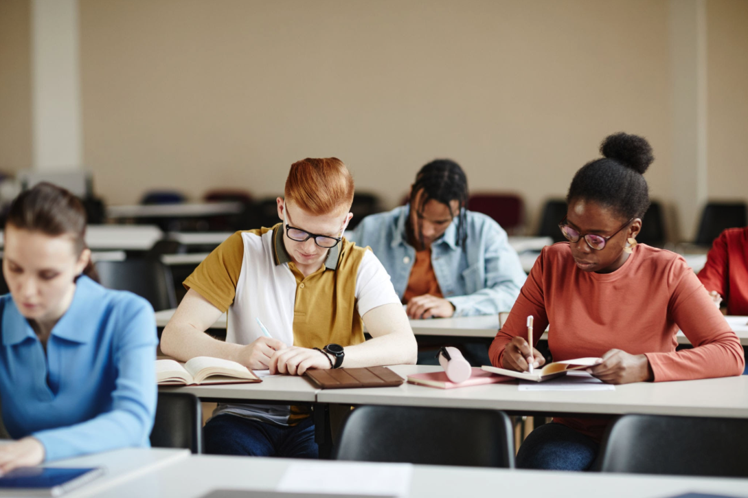Students taking a language exam in a classroom